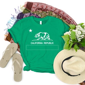 May include: A green t-shirt with a white outline of the California bear and the words "CALIFORNIA REPUBLIC" printed on the front.