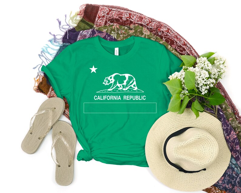 May include: A green t-shirt with a white outline of the California bear and the words "CALIFORNIA REPUBLIC" printed on the front.