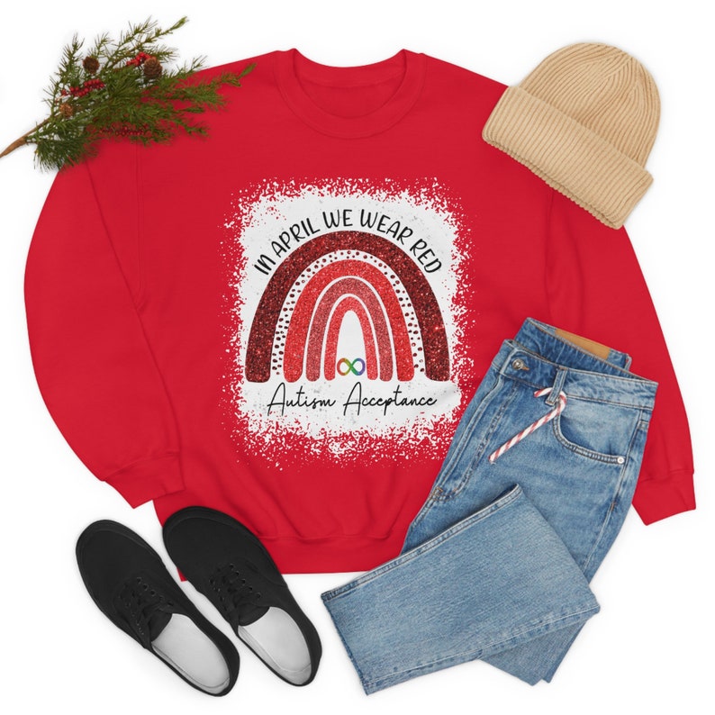 May include: Red sweatshirt with a rainbow design and the text "In April We Wear Red Autism Acceptance".