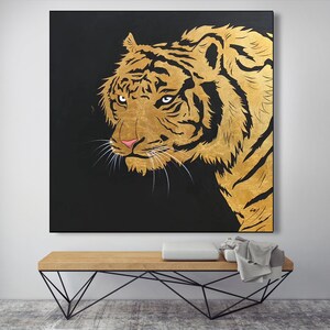 May include: A close-up of a golden tiger's face against a black background. The tiger's eyes are sharp and intense, and its fur is detailed with gold paint.