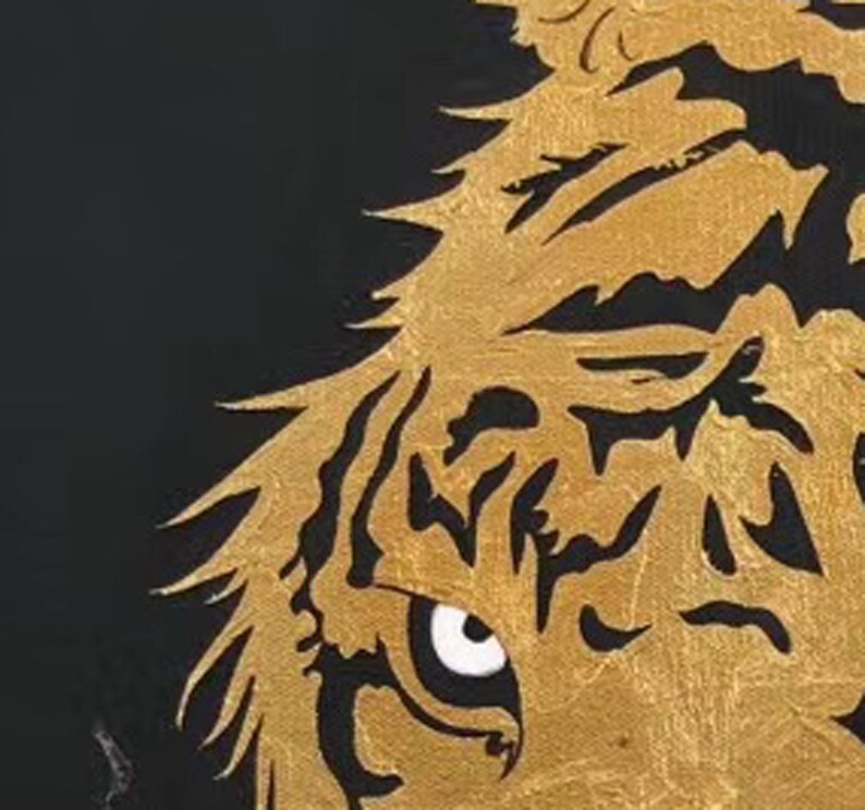 May include: Close-up of a gold tiger's eye with black stripes. The eye is partially open and the tiger's fur is textured.