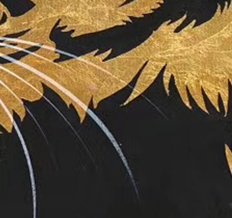 May include: Close-up of a black and gold cat illustration. The cat's fur is depicted with gold paint, and its whiskers are white.