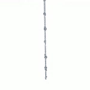May include: A delicate silver necklace with multiple small, round, clear gemstones evenly spaced along the chain. The necklace is displayed against a white background, highlighting its simple elegance. The chain is approximately 18 inches long.