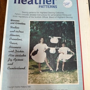May include: A vintage sewing pattern by "heather PATTERNS" for Highland Dancing costumes. The cover shows two people in white dresses and bloomers. The pattern includes instructions for blouses, crinolins, trews, bloomers, and other items.