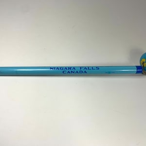 Vintage giant pencil from Niagara Falls with rotating tin globe topper