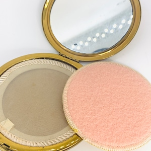 Vintage geometric pattern gold tone compact with unused powder puff