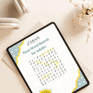 May include: A digital tablet displaying a Farsi word search puzzle for adults. The tablet has a black bezel and the screen shows a grid of Farsi letters. The word search is titled "Farsi Word Search for Adults" with the ZABAN logo. A pair of white headphones rests nearby.