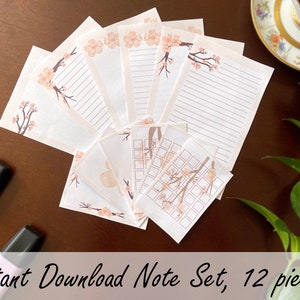 Puede incluir: Un conjunto de 12 tarjetas de notas imprimibles con un delicado diseño floral con flores rosadas y ramas. Las tarjetas tienen secciones rayadas y cuadriculadas para escribir.