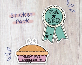 May include: A sticker pack with two stickers. One sticker is a blue and white ribbon with a star and the text "Star Baker". The other sticker is a pink pie with the text "Nobody likes a soggy bottom".