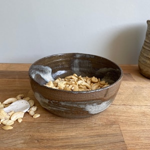 Handmade stoneware ceramic bowl made of brown clay - earthy colors, edible and decorative