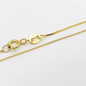 May include: A gold chain necklace with a lobster clasp and a small tag that says "10K" on it.