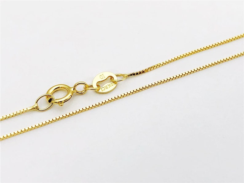 May include: A gold chain necklace with a lobster clasp and a small tag that says "10K" on it.