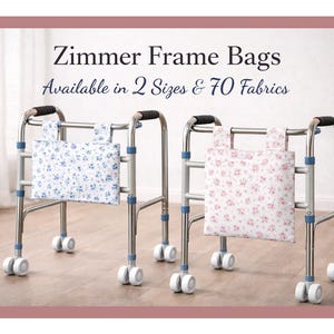 May include: Two Zimmer frame bags, one with a blue floral pattern and the other with a pink floral pattern, are attached to silver walkers. The bags are rectangular with handles. Text at the top reads "Zimmer Frame Bags Available in 2 Sizes & 70 Fabrics."