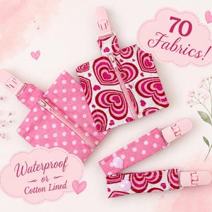 May include: Two square pouches and two straps with pink plastic clips. One pouch features a red and pink heart pattern, the other a pink and white polka dot pattern. Both have zippers. Text reads 70 Fabrics! and Waterproof or Cotton Lined.