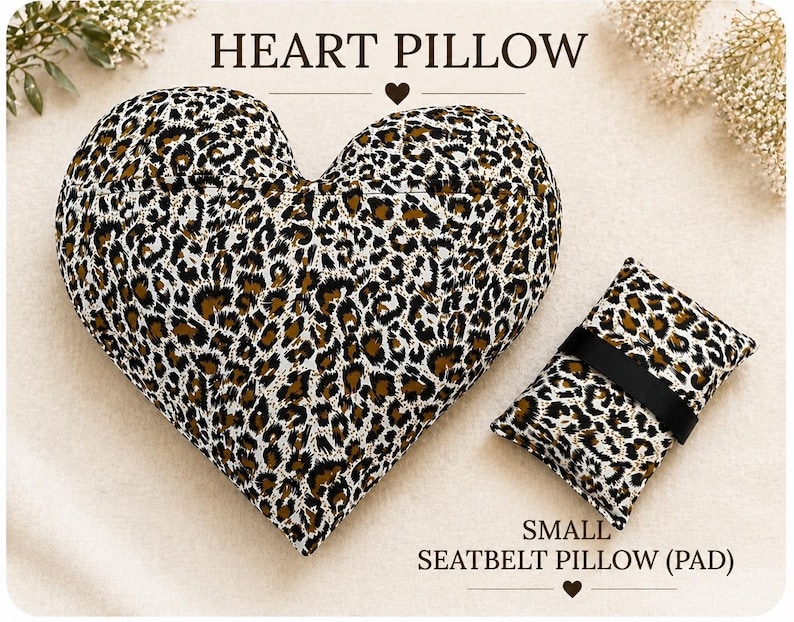 May include: A heart-shaped pillow and a small rectangular seatbelt pillow, both featuring a brown, black, and white leopard print pattern. The text HEART PILLOW is centered above the heart, and SMALL SEATBELT PILLOW (PAD) is below the rectangular pad.