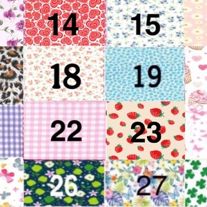 May include: A grid of sixteen fabric swatches labeled 13 through 28, featuring various patterns including purple flowers, red hearts, blue floral, daisies, leopard print, strawberries, pink cupcakes, purple gingham, pink plaid, butterflies, and green shamrocks.
