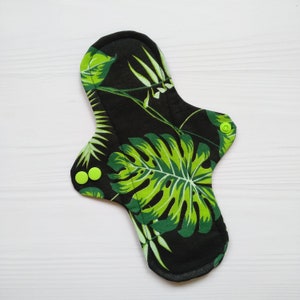 Black cloth pads with leaves. Reusable organic panty liners with wings. Flannel or fleece to the skin. Zero waste menstrual napkins.