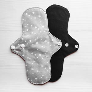 Gray cloth pads with stars. Reusable menstrual sanitary napkins. Eco friendly zero waste panty liners. Various flow and lengths.
