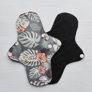 Gray reusable pads with orchids. Fabric menstrual cloth pads. Flannel (cotton) or fleece to the skin. Organic panty liners with wings.