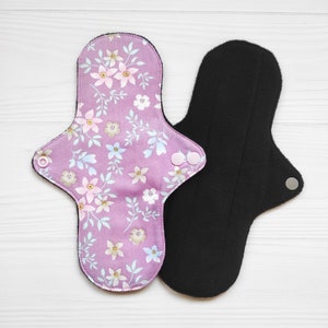 Pink reusable cotton cloth pads with flowers. Zero waste organic panty liners. Non-slip sanitary napkins.