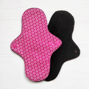 Cotton cloth pads with flowers. Reusable menstrual panty liners. Eco sanitary napkins. Flannel or fleece to the skin. Zero waste period pads