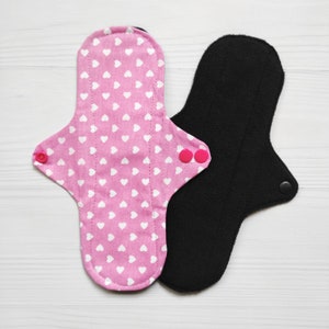 Cotton menstrual pads with hearts. Reusable cloth pad with wings. Organic flannel or fleece with bamboo to the skin. Zero waste panty liners