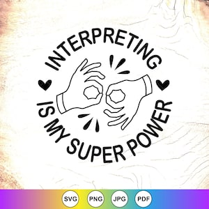 May include: Black and white graphic with the text "INTERPRETING IS MY SUPER POWER" in a circular design. Two hands are shown signing, with hearts and bursts of lines. The image is on a light wood grain background.