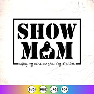 May include: Black and white graphic design with the words "SHOW MOM" in bold, block letters. A goat silhouette is inside the "M" of MOM. The text "losing my mind one show day at a time" is below.