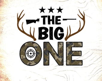 May include: A graphic design with the text "THE BIG ONE", with a camouflage-patterned "ONE". The design includes a rifle, three stars, and deer antlers. The letter "O" has a target symbol.