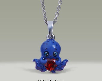 May include: A silver chain necklace with a blue octopus pendant holding a red heart-shaped gemstone. The pendant says "Hold My Heart - OCTOPUS"