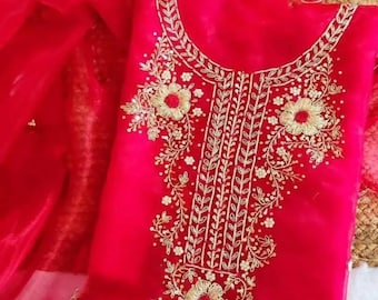 May include: A vibrant red garment with intricate gold embroidery. The embroidery features floral and leaf patterns around the neckline and bodice. The fabric appears to be a lightweight, sheer material.