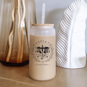 May include: A white reusable tumbler with a black and white graphic of a dragon with the text "Basgiath War College" and "Dragon Rider" printed on the side.