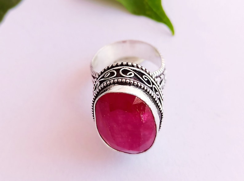 Peut inclure: Une bague en argent avec une pierre pr&eacute;cieuse rose ovale sertie dans une bande d'argent d&eacute;corative.