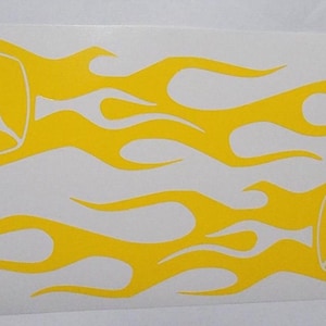 May include: Two yellow flame decals with the John Deere logo. Each decal features a white deer inside a yellow square, with yellow flames extending to the side. The decals are on a white background.