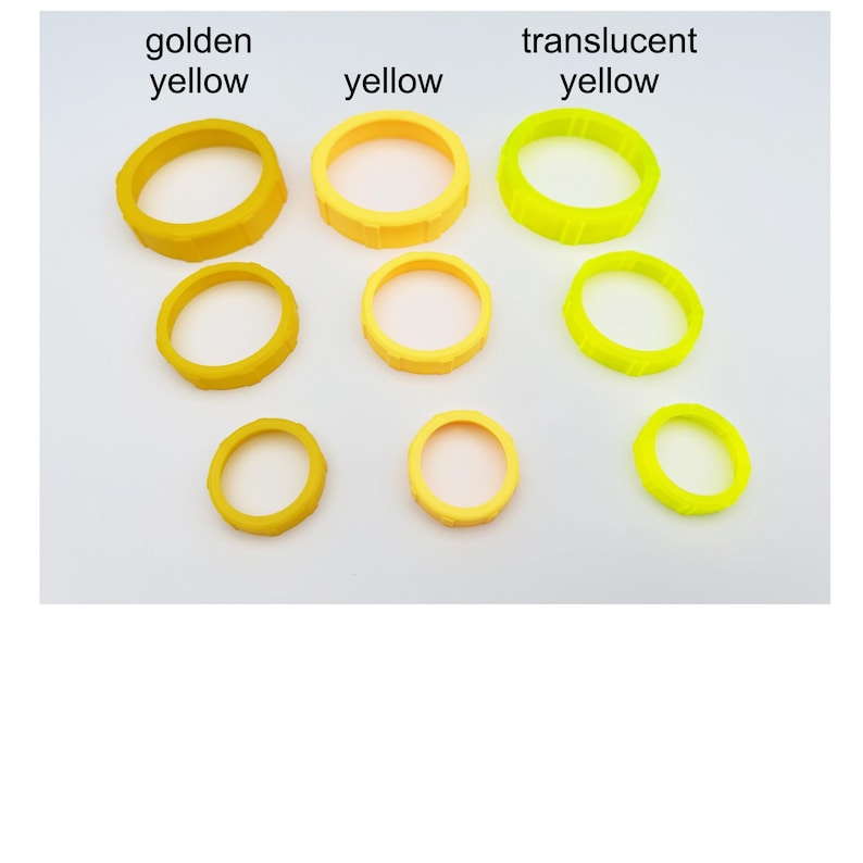 May include: A collection of yellow rings in varying shades: golden yellow, yellow, and translucent yellow. The rings are arranged in rows, with three different sizes of each color. The text labels each color.