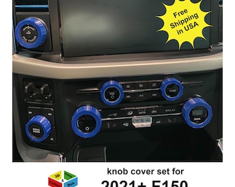 Può includere: Un set di copri manopole blu per un camion F150 2021+. I copri manopola sono progettati per adattarsi alle manopole esistenti sul cruscotto, comprese quelle per la radio, il climatizzatore e la modalità di guida. Il testo "PRO TRAILER", "VOL", "TUNE" e "DUAL" sono visibili.