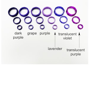 May include: An assortment of purple, violet, and lavender-colored ring-shaped objects. The rings vary in size and shade, ranging from dark purple to translucent violet. Text labels identify the colors.