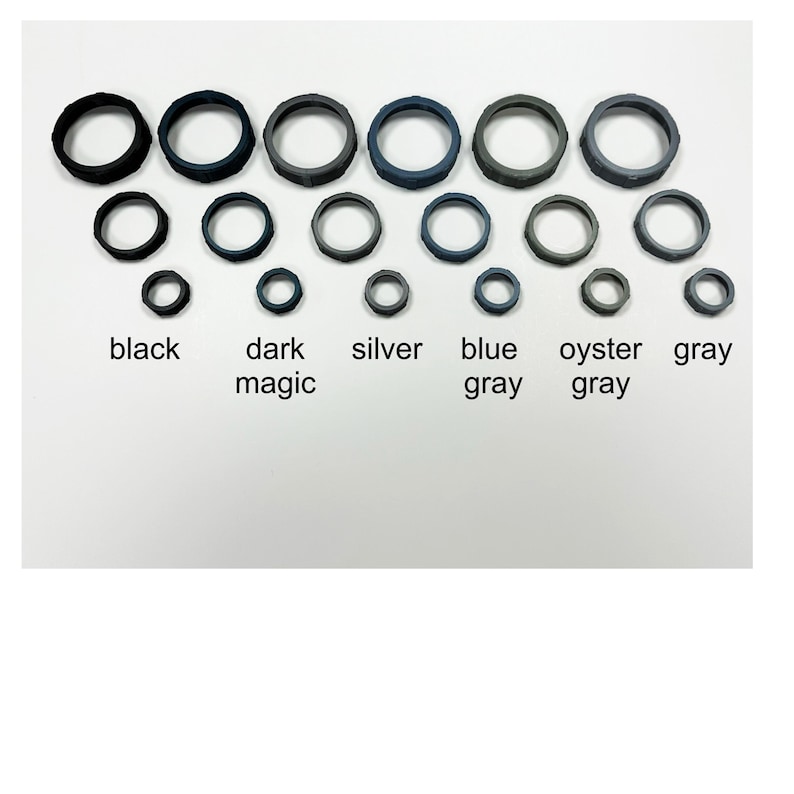 May include: A collection of rubber rings in various sizes and colors, including black, dark magic, silver, blue gray, oyster gray, and gray. The text labels each color. The rings are arranged in rows and columns.