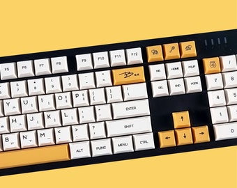 May include: A white and black keyboard with yellow keys. The keyboard has a variety of keys, including function keys, number keys, and letter keys. The keyboard also has a key with the word "Bee" on it.