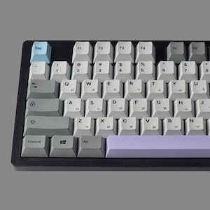 May include: A white and grey mechanical keyboard with a light blue escape key and a purple space bar. The keyboard has Korean and English lettering on the keys.