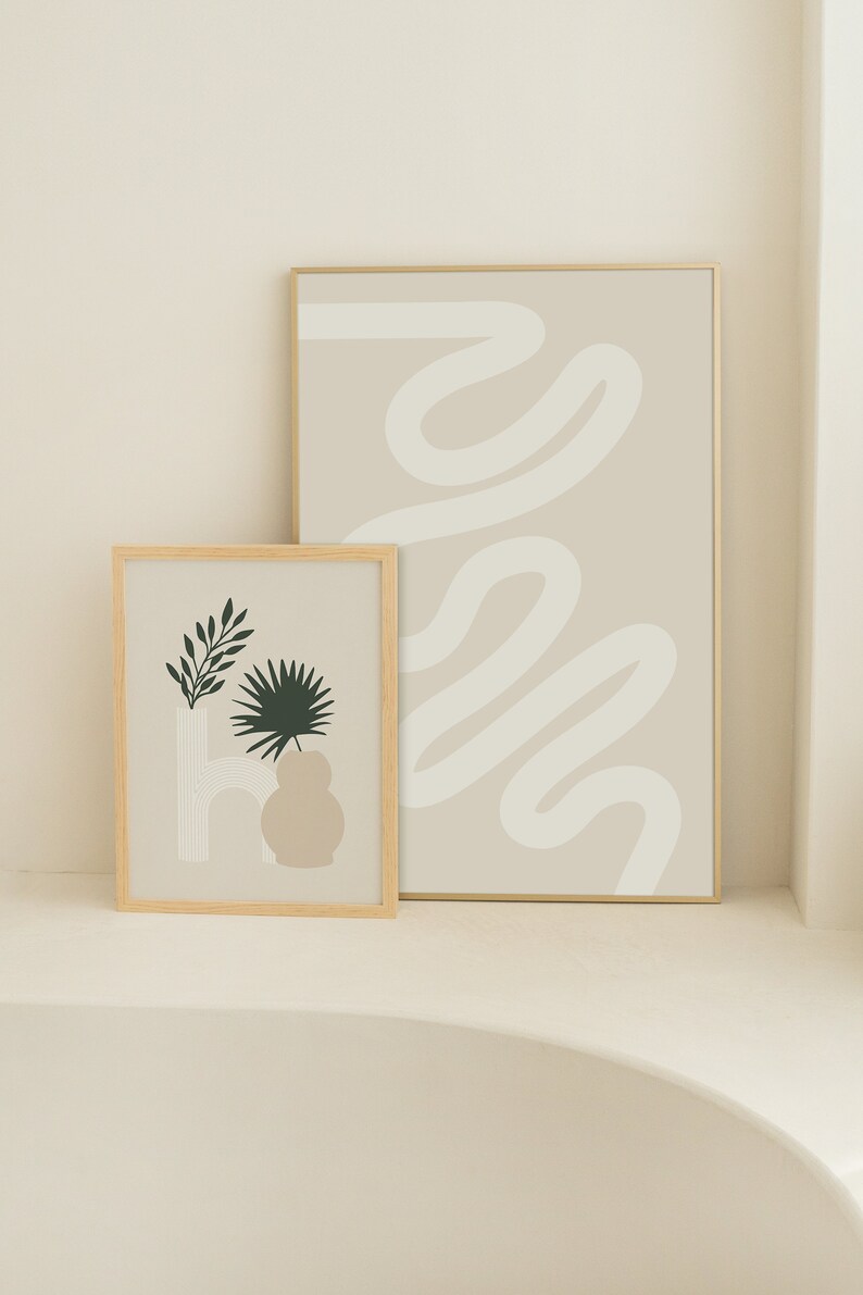 May include: Two framed prints with minimalist abstract designs. The print on the left features a stylized plant in a vase with a beige background. The print on the right features a white abstract line design on a beige background.