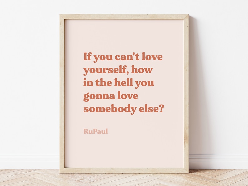 May include: A framed print with a pink background and a quote in brown text: "If you can't love yourself, how in the hell you gonna love somebody else?" - RuPaul.