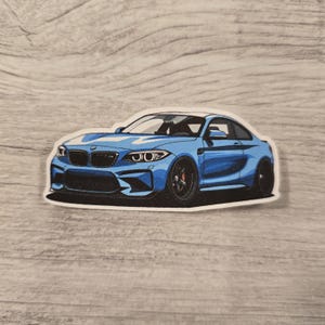 May include: A blue BMW M4 sports car sticker. The car is depicted in a cartoon style with a white background.
