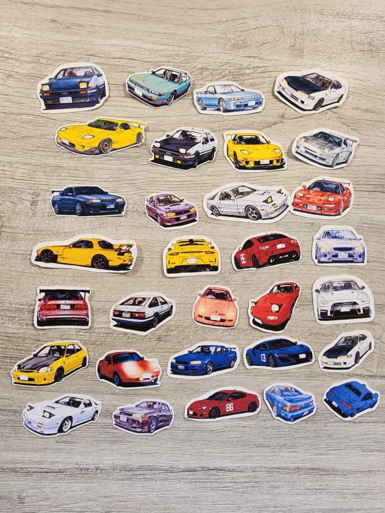May include: A collection of 30 colorful car stickers featuring various makes and models of Japanese sports cars. The stickers are printed on white paper and have a glossy finish.