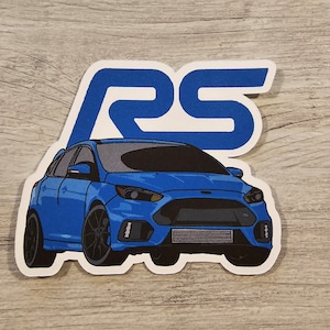 May include: A blue Ford Focus RS car sticker with the letters RS in blue on a white background.