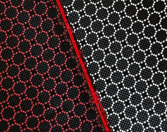 May include: Two fabric swatches with a geometric pattern of circles and dots. The fabric on the left is black with red circles and dots. The fabric on the right is black with white circles and dots.