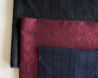 May include: Three fabric swatches with a vertical striped pattern. The top swatch is black, the middle swatch is red, and the bottom swatch is navy blue.