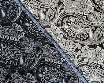 May include: Two fabric swatches with a paisley pattern. The top swatch is a dark brown fabric with a silver paisley pattern. The bottom swatch is a dark blue fabric with a silver paisley pattern.