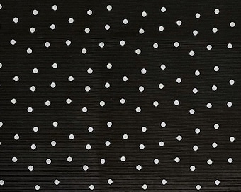May include: Black fabric with a white polka dot pattern.