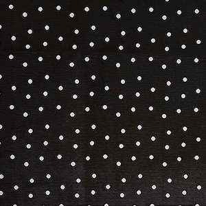 May include: Black fabric with a white polka dot pattern.